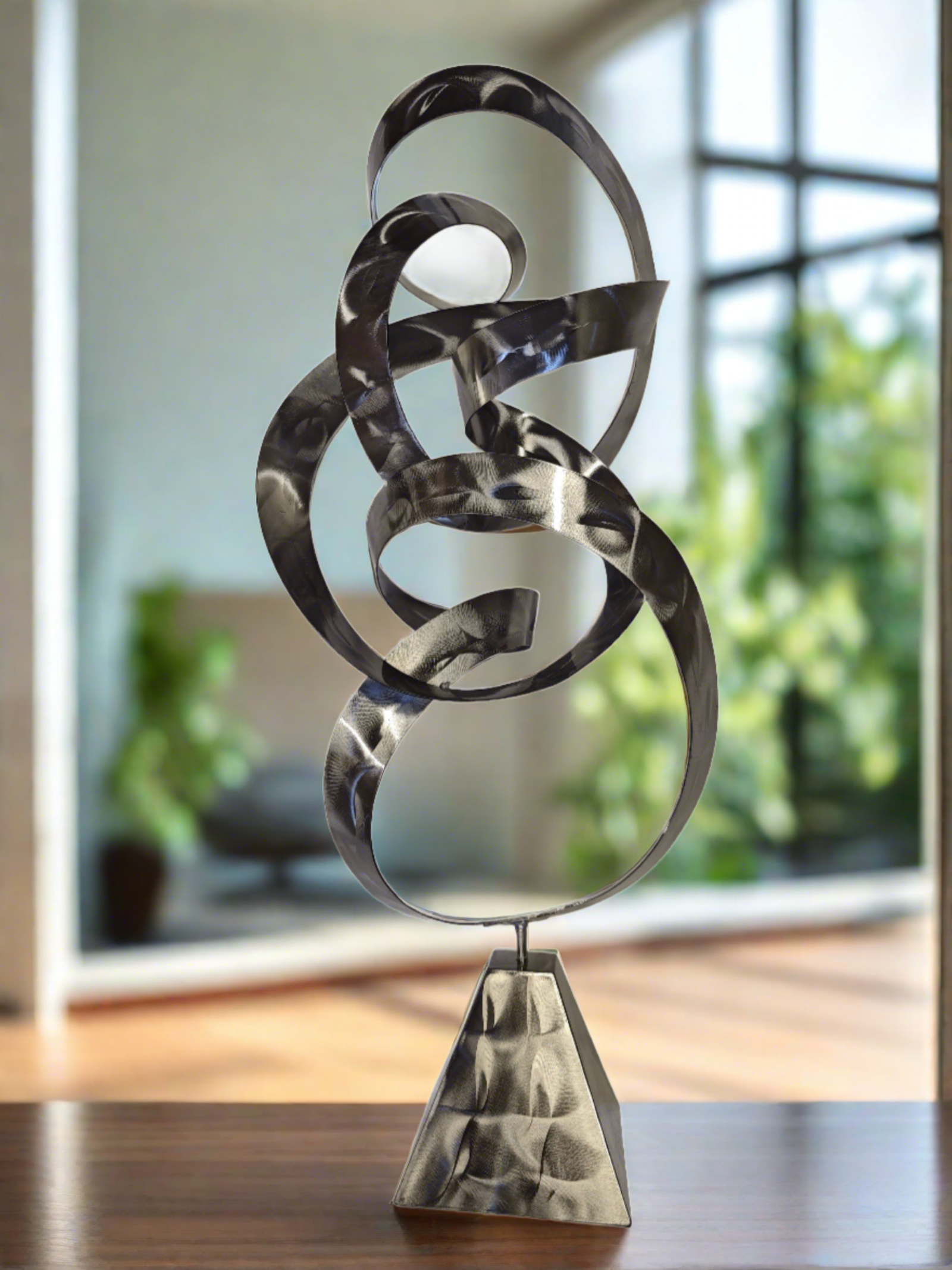 Infinite Path Metal Sculpture with swirling abstract form and polished stainless steel finish, symbolizing movement and mindfulness.