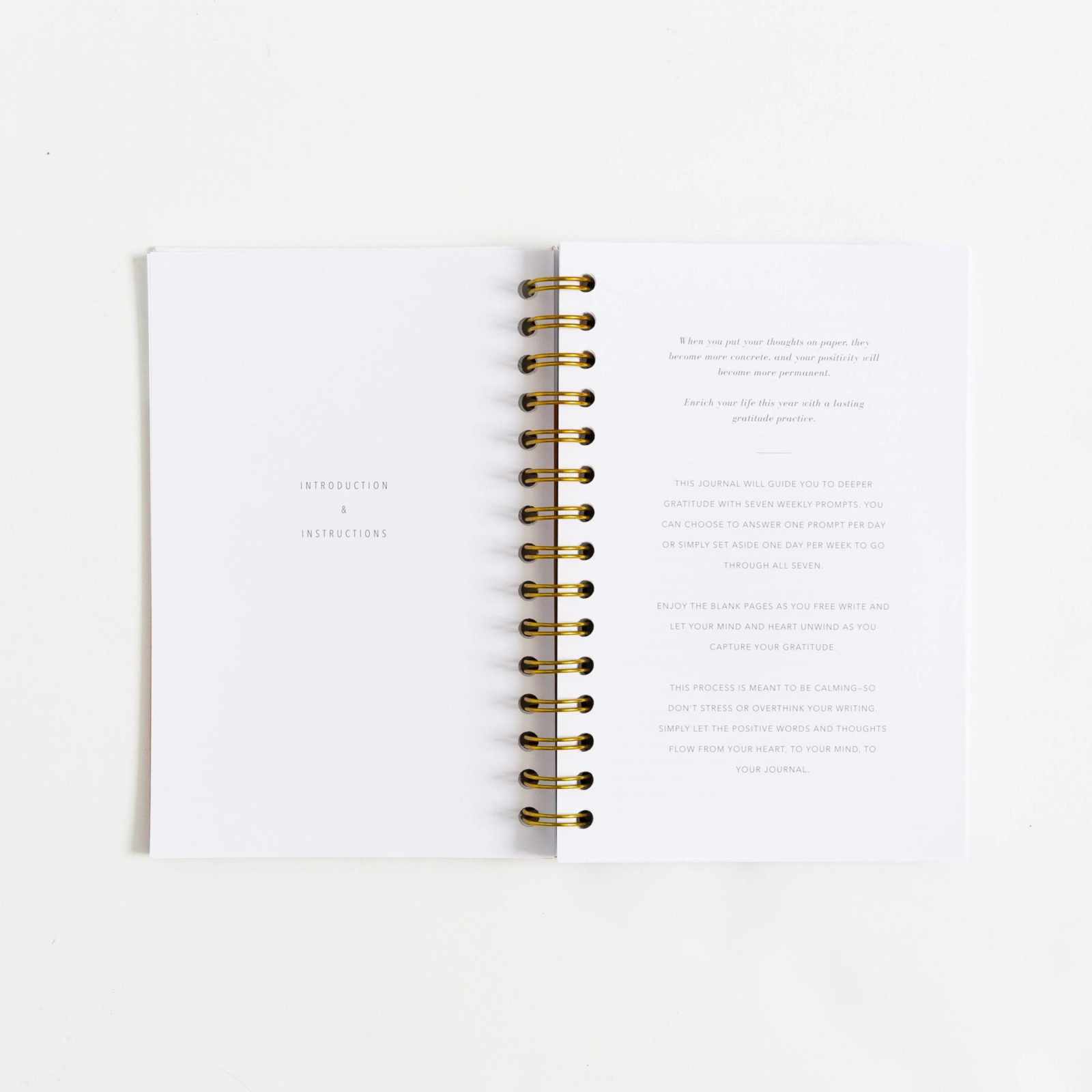 Open Gratitude Journal with weekly prompts and reflection spaces, featuring an elegant linen cover for cultivating mindfulness and positivity.