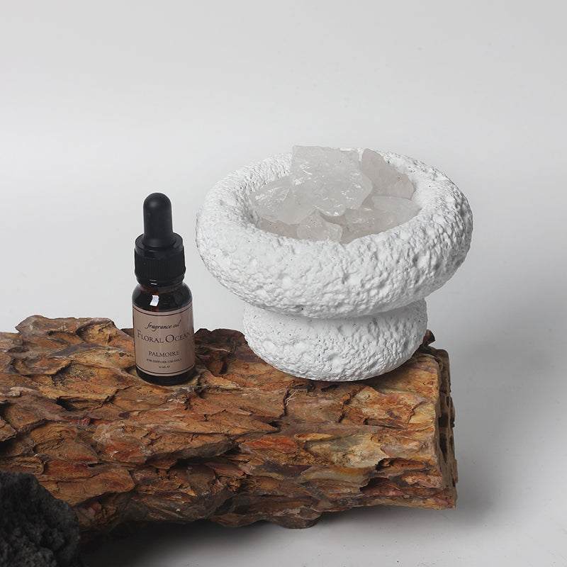 White Moon Diffuser with Floral Ocean fragrance bottle on rustic wood background.