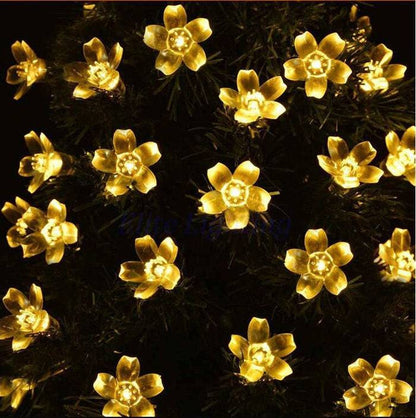 Cherry Blossom Solar LED String Lights illuminating in warm yellow on a dark background, weatherproof, wireless, and solar-powered by VistaShops.