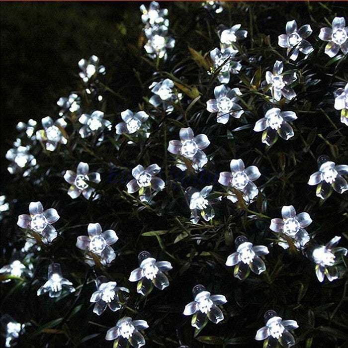 Cherry Blossom Solar LED String Lights illuminating a garden at night with bright white LED flowers.