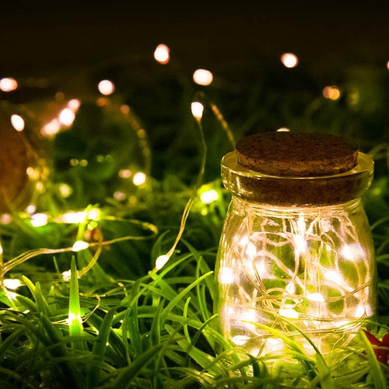 Solar-powered Mini Fiery 100 Lights in jar illuminating outdoor space.