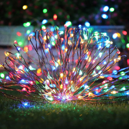 Solar-powered Mini Fiery 100 Lights in multi-color setup on grass, ideal for festive outdoor decor.