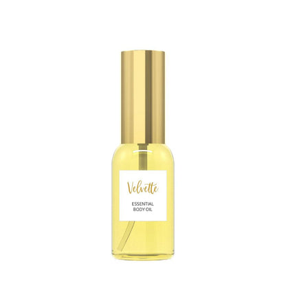 Velvette Essential Body Oil bottle with gold cap, featuring organic jojoba and lemongrass oils.