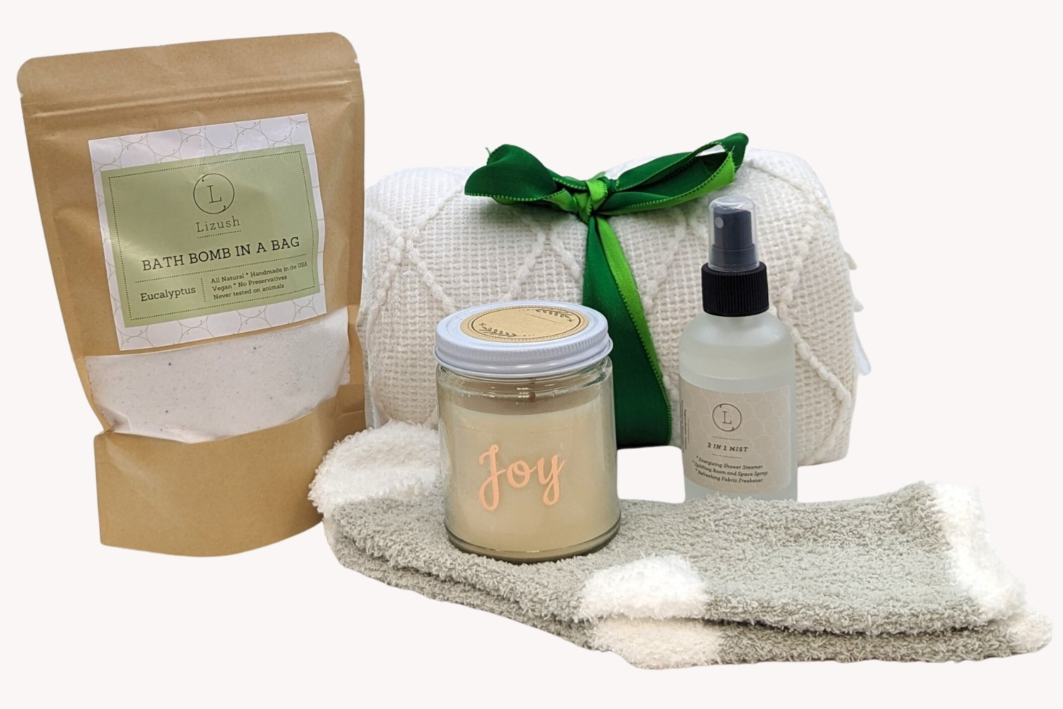 Gift set with blanket, soy wax candle, shower mist, fluffy socks, bath fizz, and personalized greeting card.