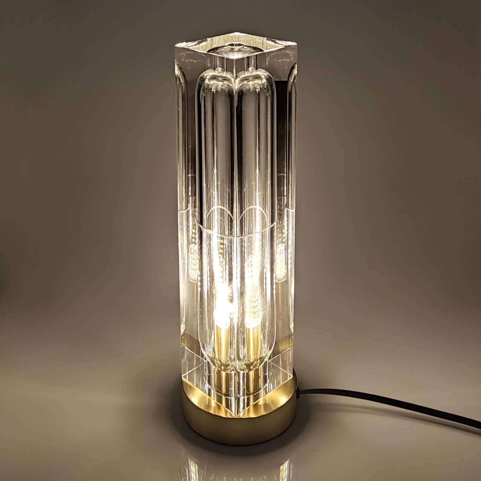 Crystal LED table lamp with rectangular crystal lampshade and brass base for modern elegance.