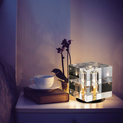 Lucent Crystal LED Table Lamp with rectangular crystal shade and brass base on a bedside table.