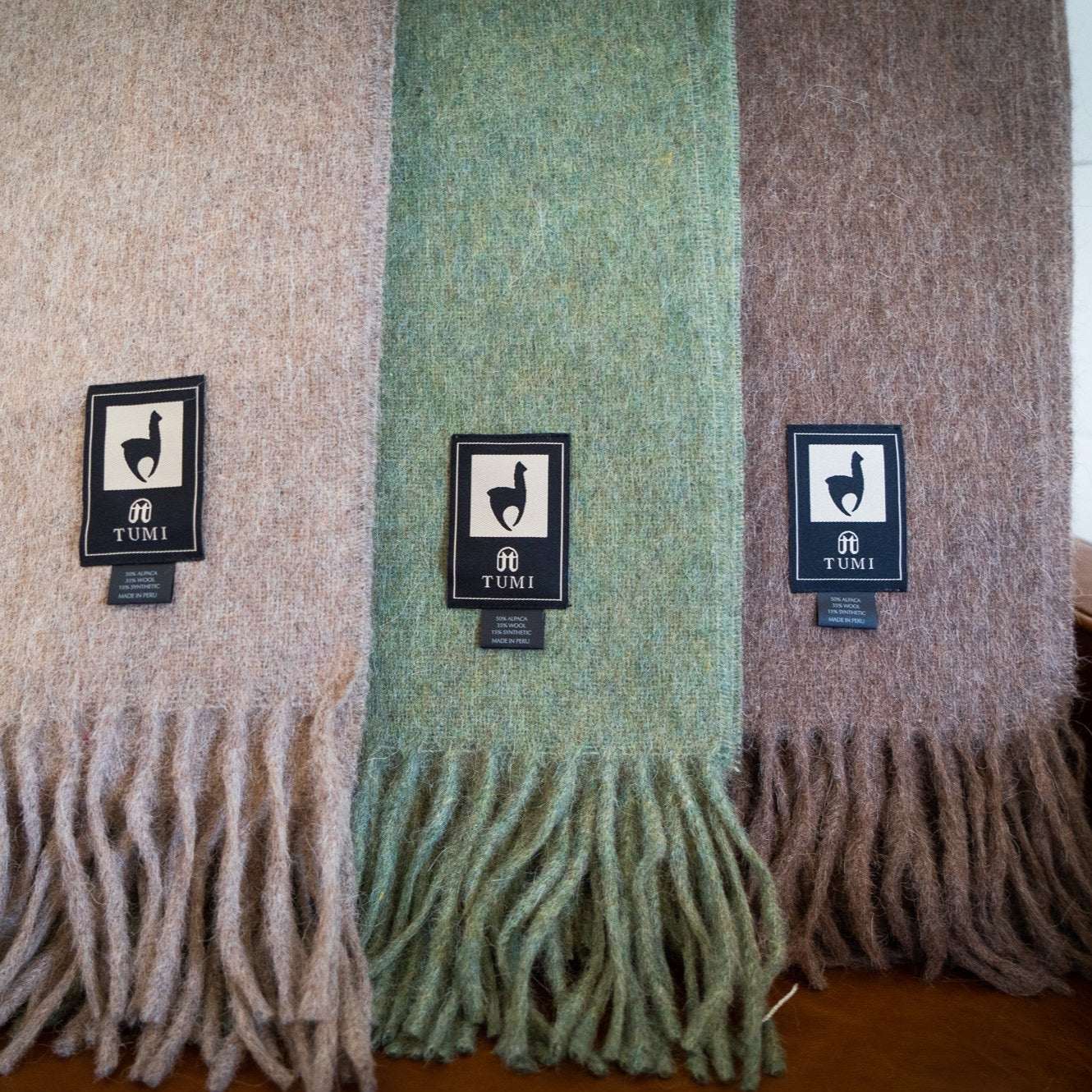 Alpaca wool throw blanket in solid colors with fringe, made in Peru.