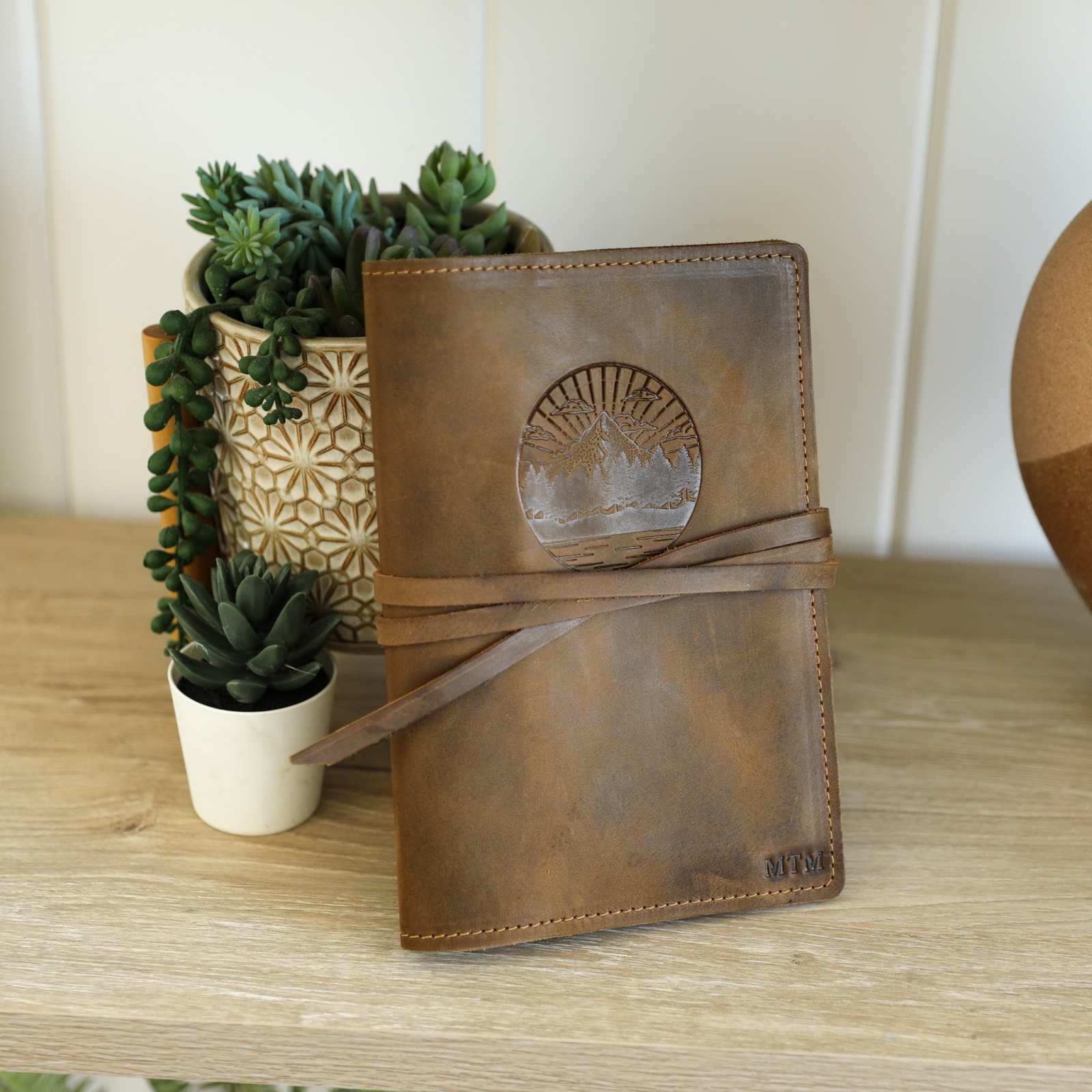 Handcrafted full-grain leather journal with card sleeve and pockets, includes lined kraft paper, customizable.