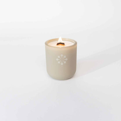 Fireside Comfort Candle in cream jar, creating a warm and cozy atmosphere.