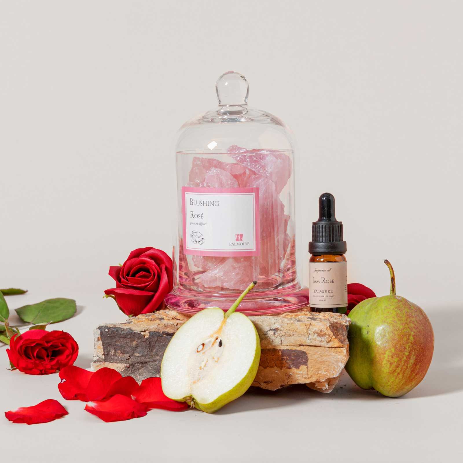 Blushing Rosé Gemstone Diffuser with Jam Rose fragrance oil, featuring pear, rose, jasmine, and white musk notes, surrounded by roses and fruit.