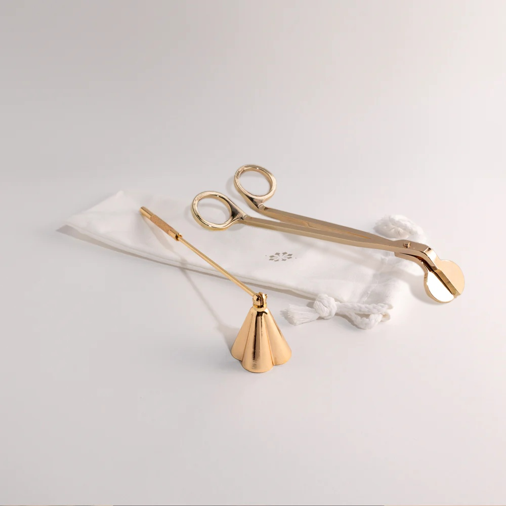 Candle snuffer and wick trimmer duo with elegant design on white background.