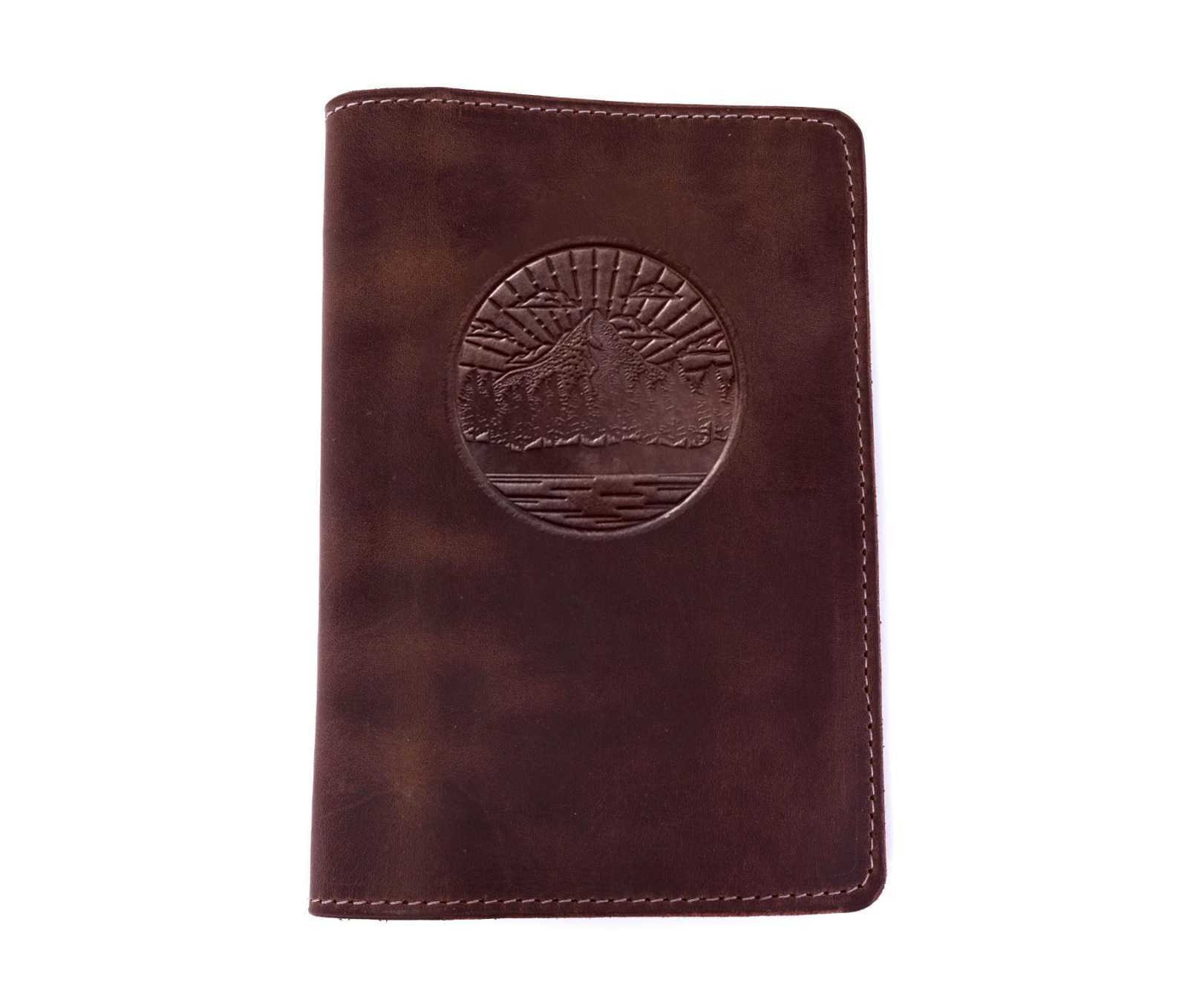 Handcrafted genuine leather journal with embossed design, available in standard and large sizes, featuring pockets and card sleeve.