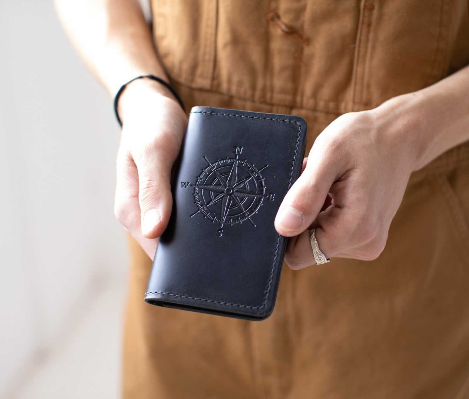 Handcrafted leather mini journal with compass design, perfect for notes on the go.