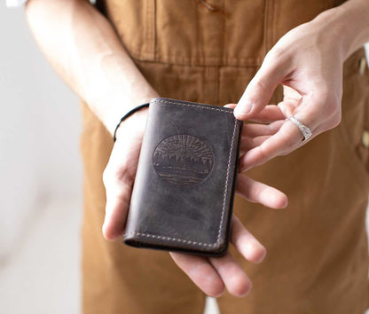 Handcrafted full-grain leather mini journal with card slot and sewn edges.