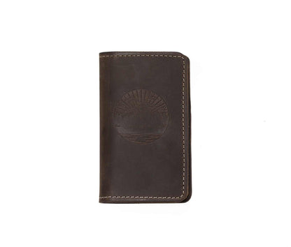 Handcrafted full-grain leather mini journal with sewn edges and embossed design.