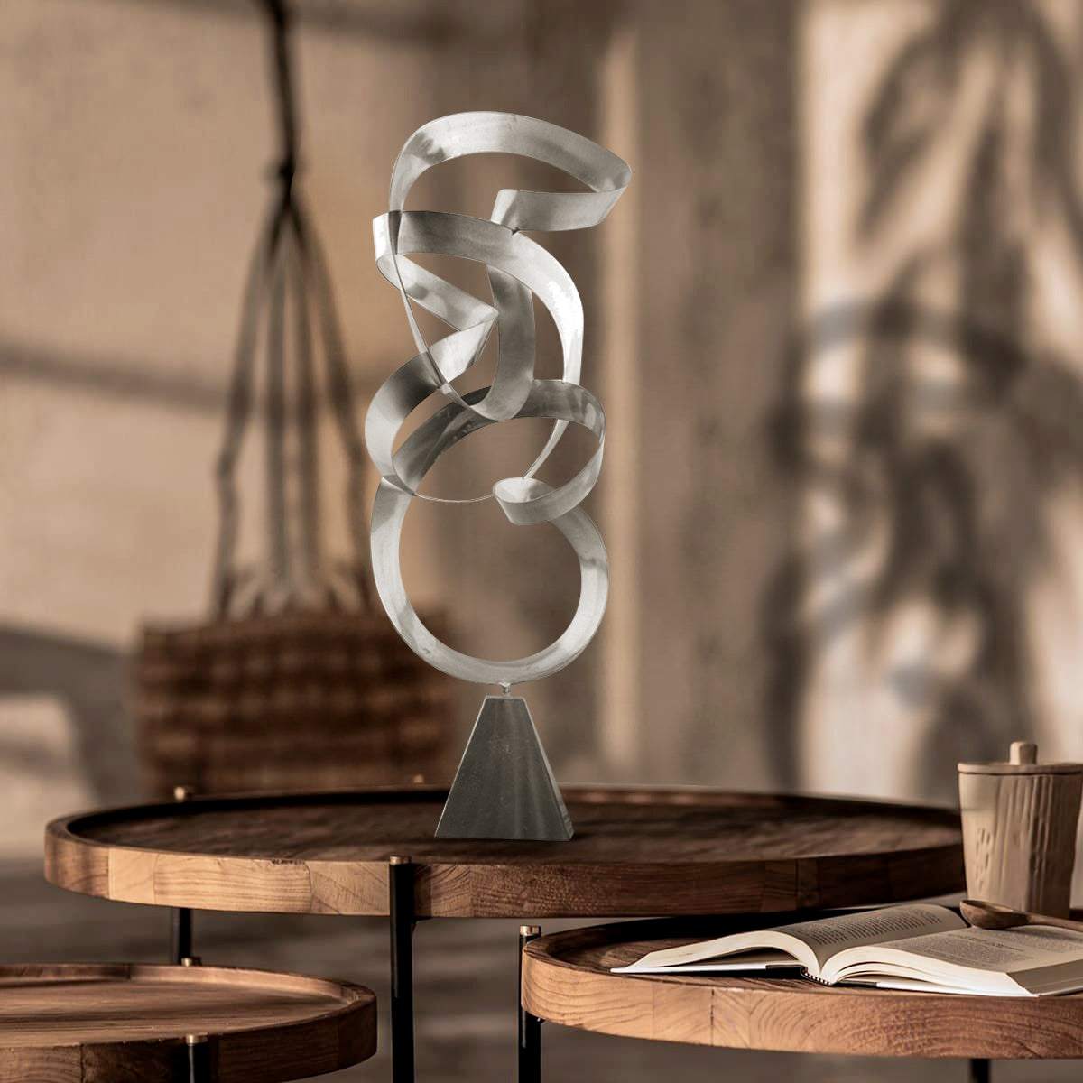 Abstract Infinite Path Metal Sculpture with stainless steel finish on a wooden table, adding modern elegance and mindfulness to interior decor.