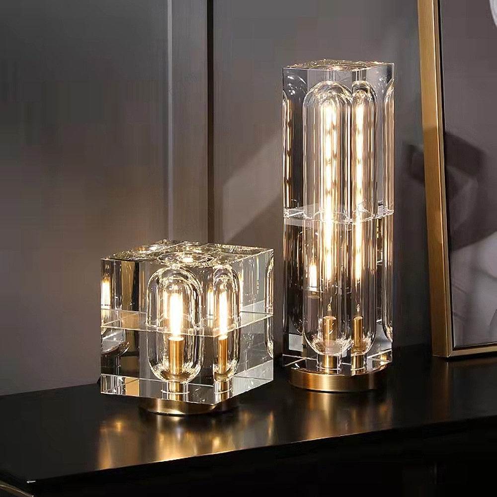 Sophisticated crystal LED table lamps with brass bases, perfect for modern elegance on a bedside table.