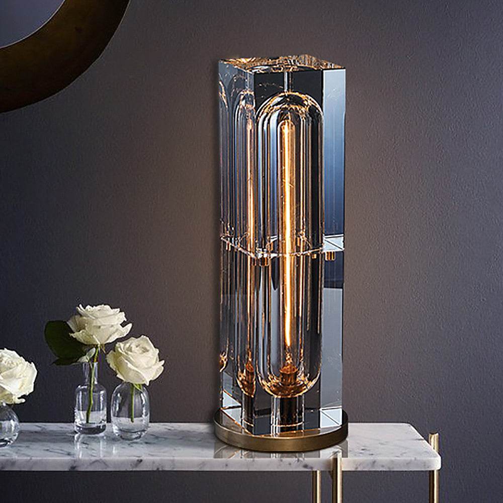 Crystal Bedside Table Lamp with brass base on a marble table, featuring a sleek rectangular crystal lampshade.