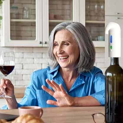 Woman enjoying wine with wine oxygenator on bottle in kitchen.