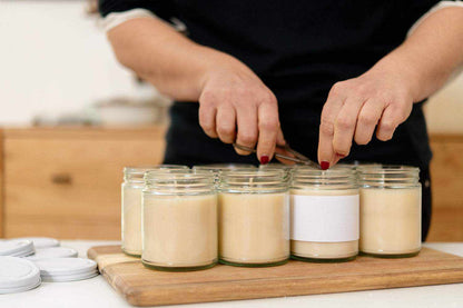 Handmade scented soy wax candles being prepared, perfect for a personalized gift set.