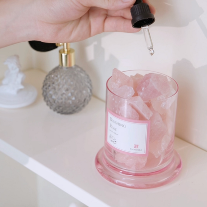 Blushing Rosé Gemstone Diffuser with rose quartz crystals and fragrance bottle on shelf.